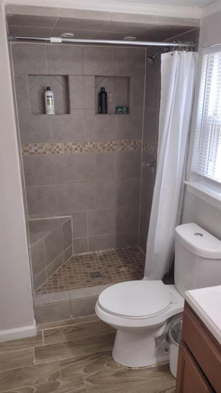 304 Ridgewood Drive Tool, TX 75143 - Photo 10 of 12 Full bath with vanity, a stall shower, and wood tiled floors