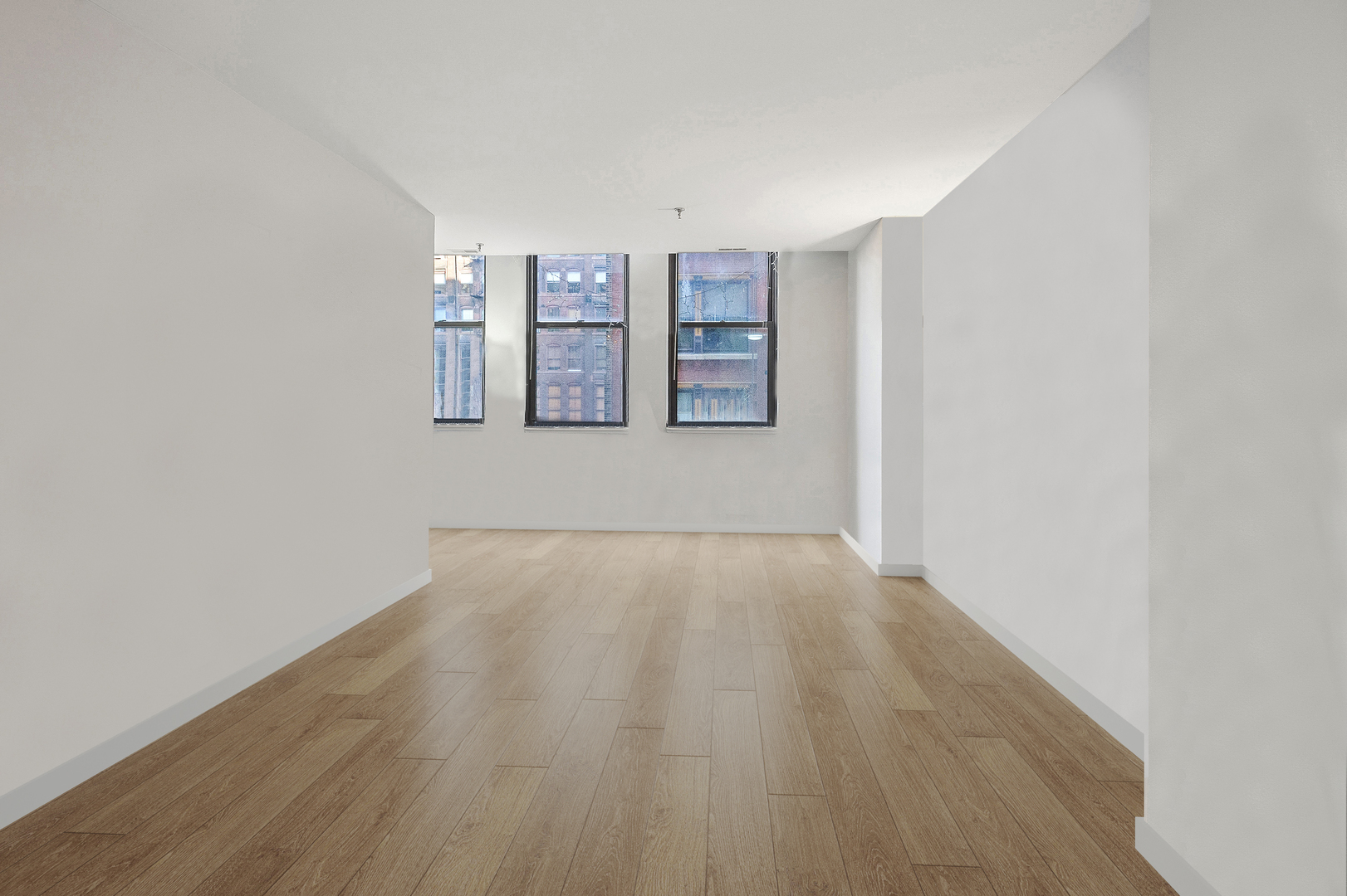 740 South Federal Street, Unit 301 Chicago, IL 60605 - Photo 3 of 10 a view of an empty room with a window and wooden floor