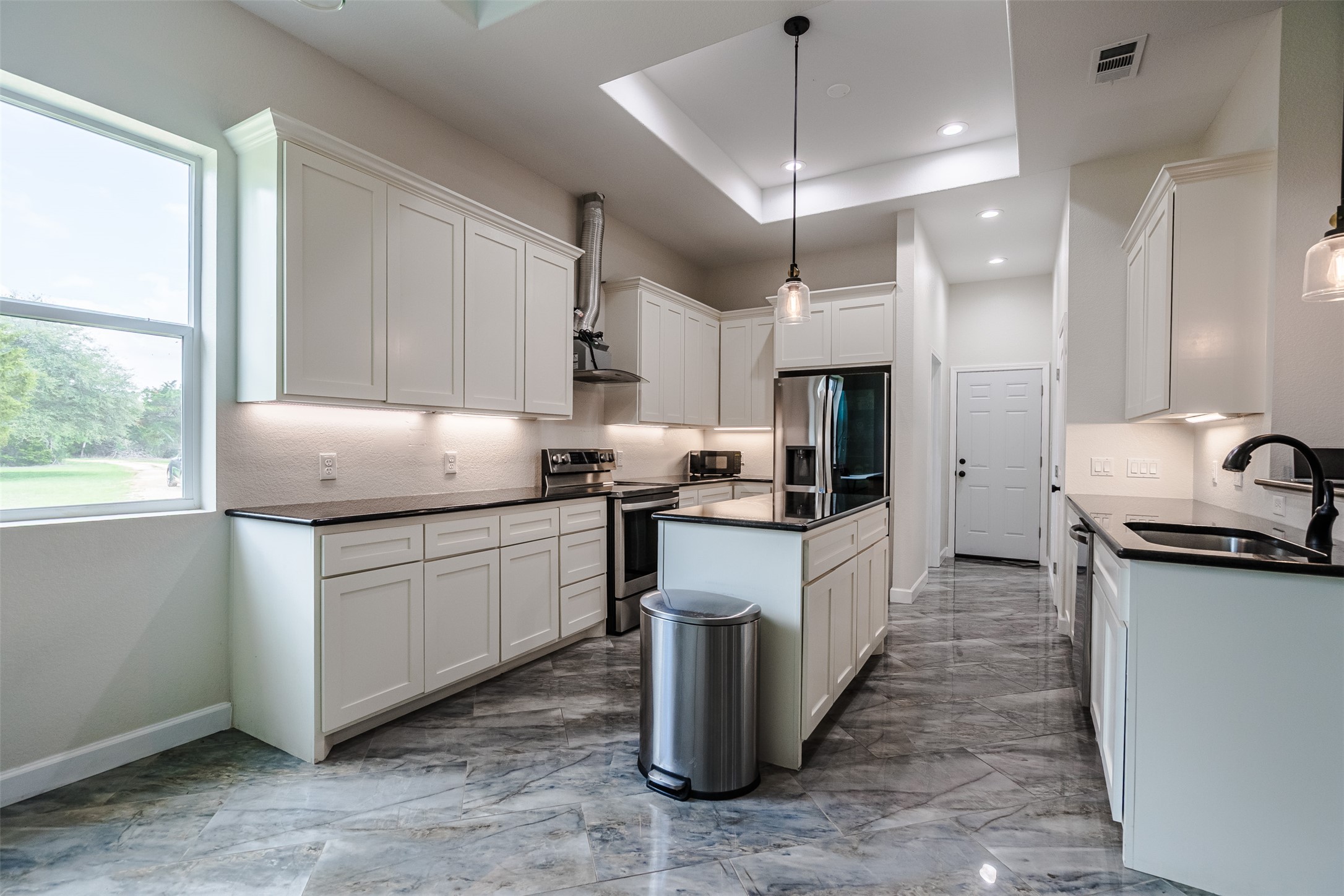 1354 Old Pin Oak Road Paige, TX 78659 - Photo 9 of 37 a kitchen with granite countertop a sink stove and refrigerator