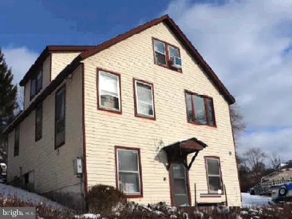 a front view of a house with garage