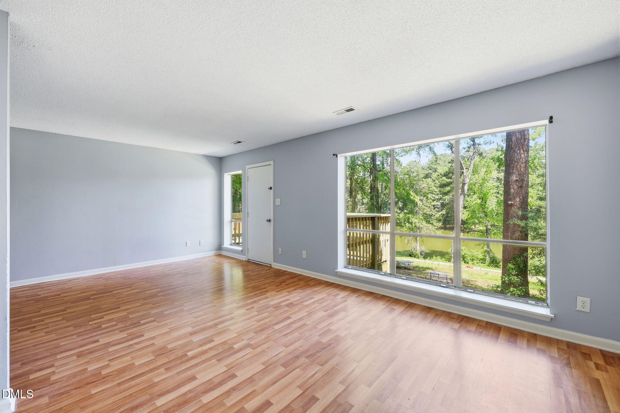 5043 Tall Pines Court Raleigh, NC 27609 - Photo 10 of 37 a view of an empty room with wooden floor and a window