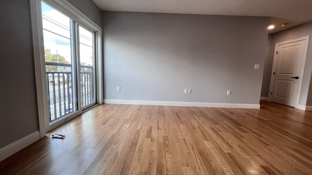 585 Washington Street, Unit MODEL2 Quincy, MA 02169 - Photo 5 of 10 wooden floor in an empty room with a window