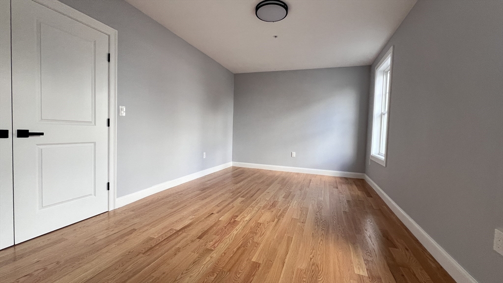 585 Washington Street, Unit MODEL2 Quincy, MA 02169 - Photo 7 of 10 a view of empty room with wooden floor