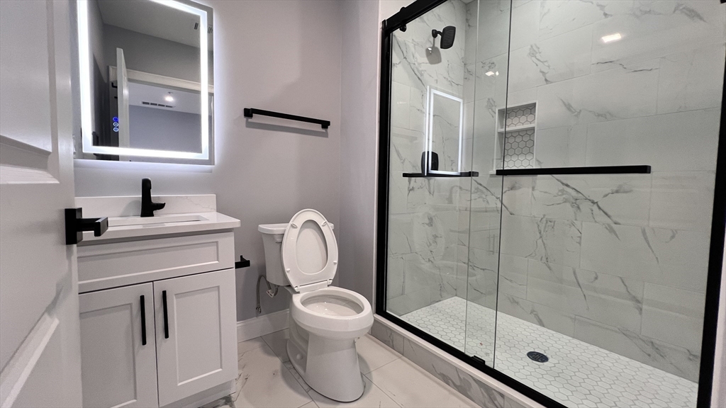 585 Washington Street, Unit MODEL2 Quincy, MA 02169 - Photo 9 of 10 a bathroom with a toilet sink and a shower