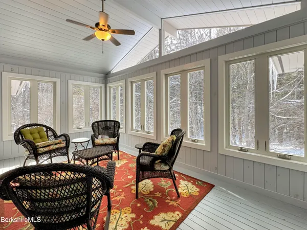 a view of a hallway with wooden floor and closet area