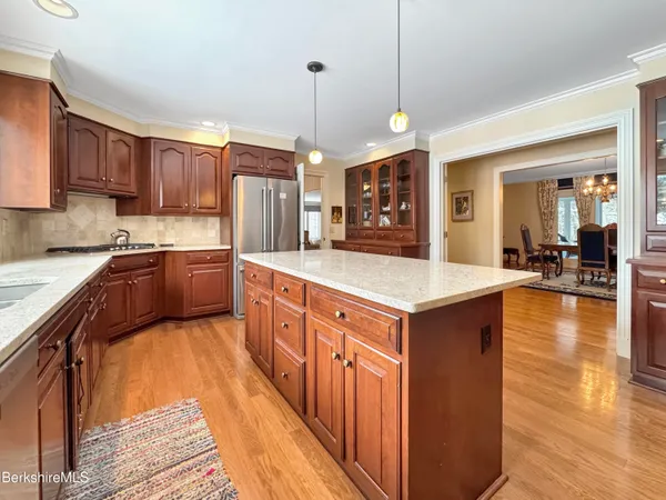 a bathroom with a granite countertop sink a mirror and a toilet