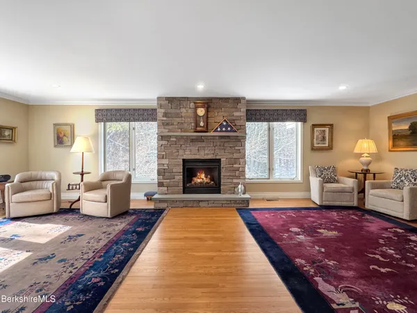 a living room with furniture a rug and a window