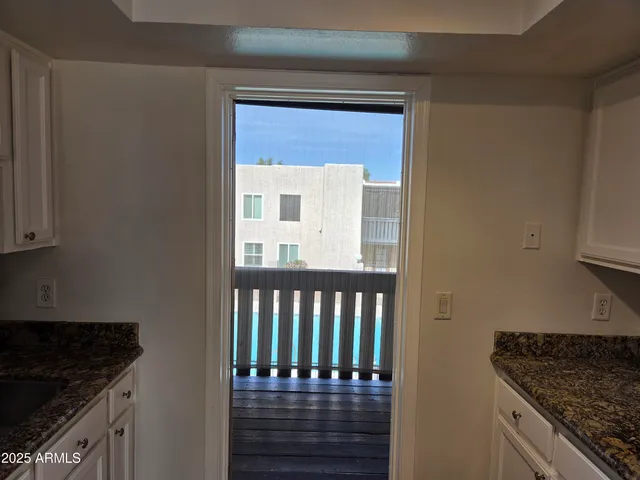 a kitchen with granite countertop a stove and a cabinets
