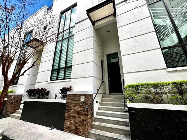 a view of a building with a window and wooden fence
