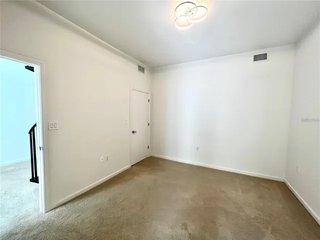 a bathroom with a granite countertop double vanity sink and a mirror