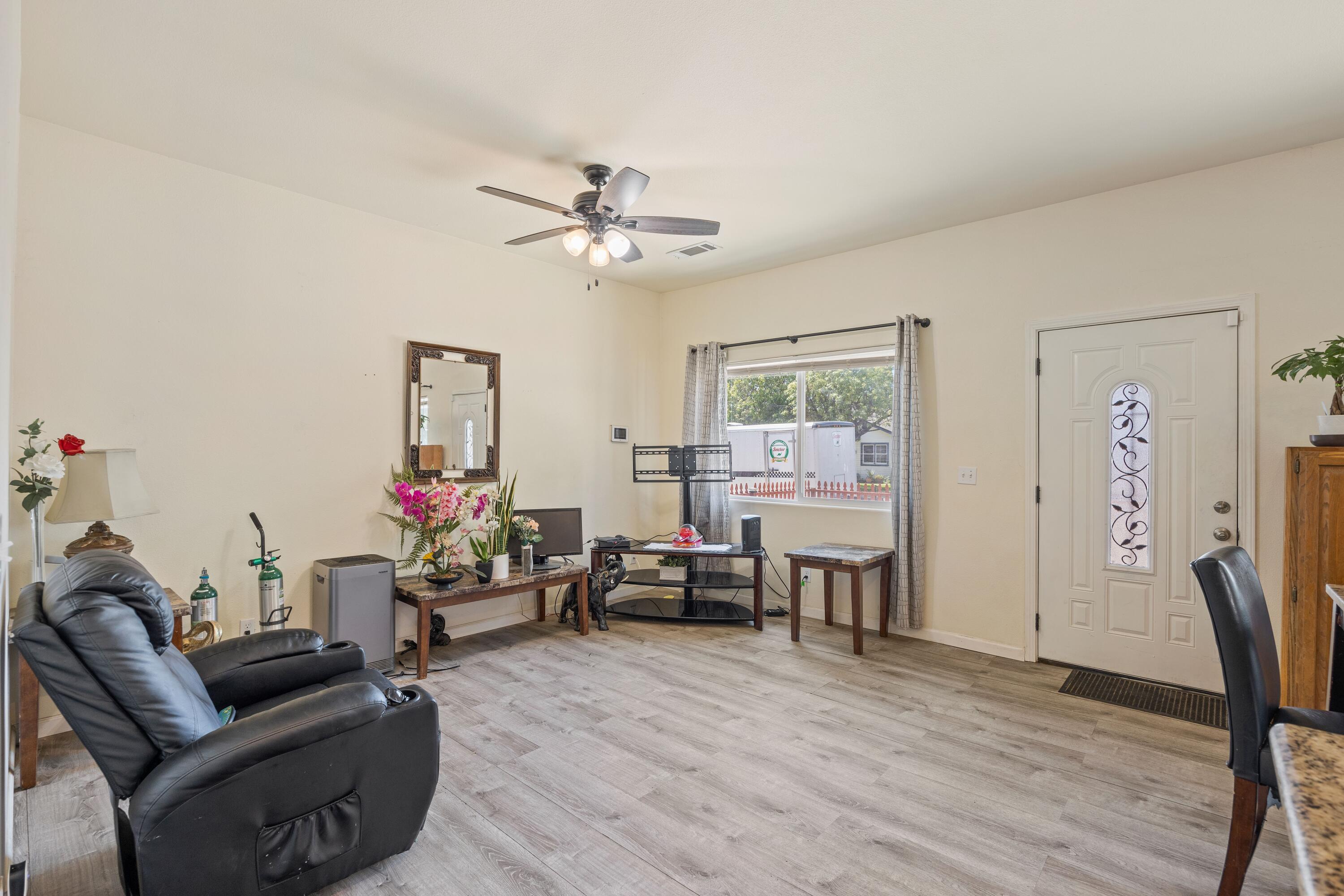 1052 South Klein Avenue Reedley, CA 93654 - Photo 2 of 10 a living room with furniture and a wooden floor