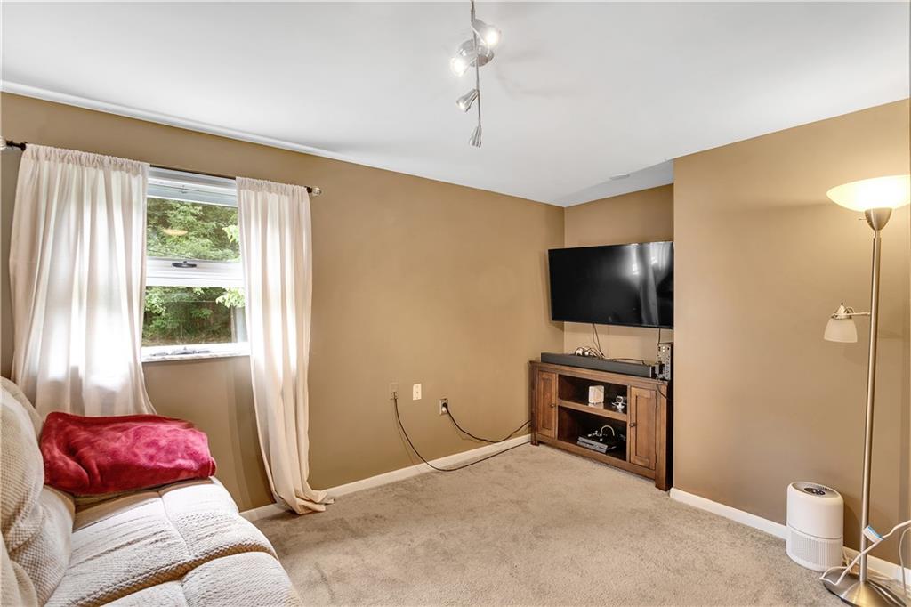 200 Evans City Road Freedom, PA 15042 - Photo 26 of 37 a bedroom with furniture and a flat screen tv
