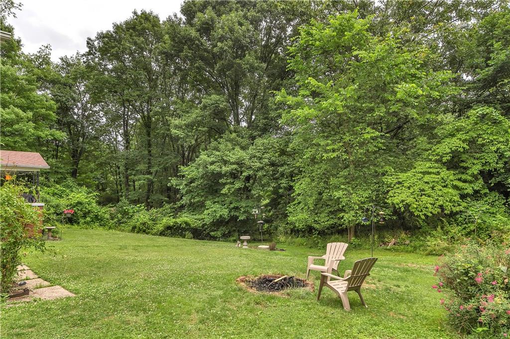 200 Evans City Road Freedom, PA 15042 - Photo 36 of 37 a garden with a bench and some trees