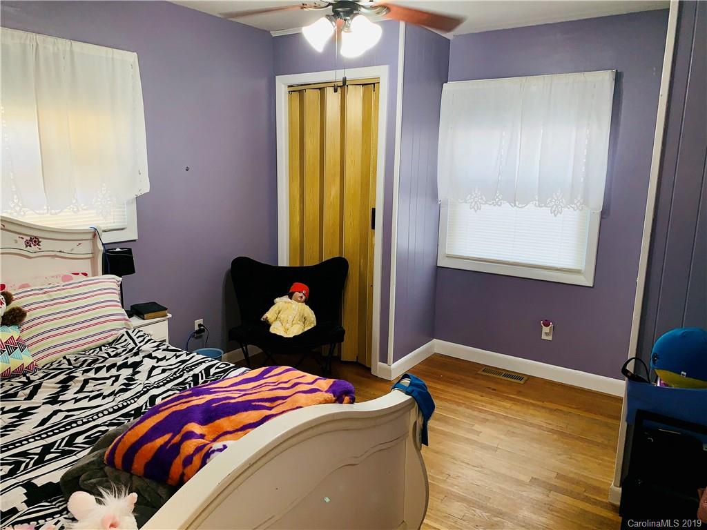 220 Pine Valley Road Salisbury, NC 28147 - Photo 20 of 29 a bedroom with a bed and a chandelier