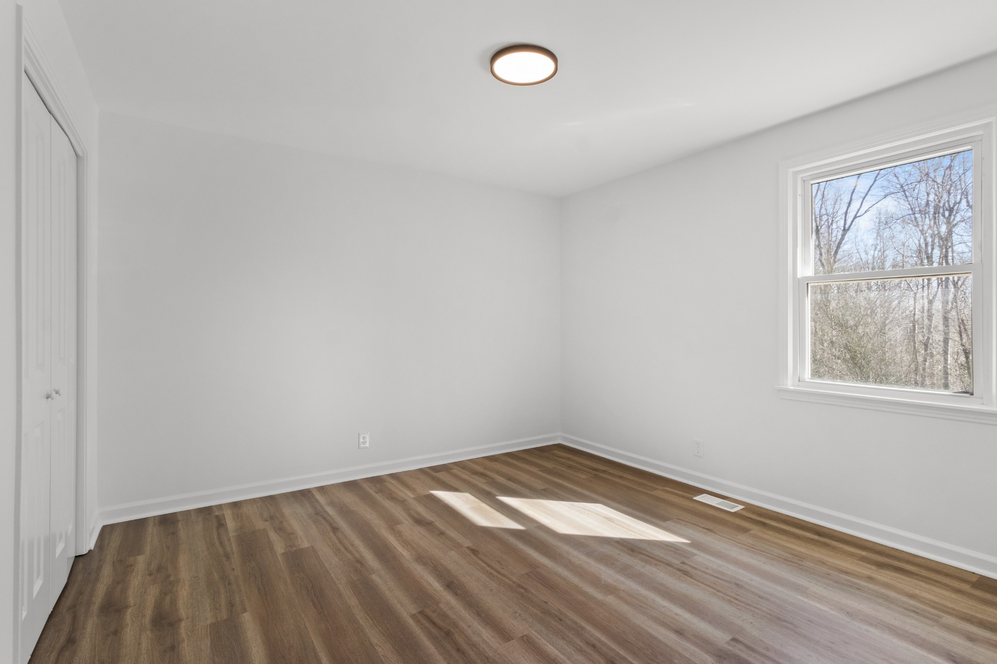1402 Southside Road Southside, TN 37171 - Photo 18 of 24 a view of empty room with wooden floor and fan