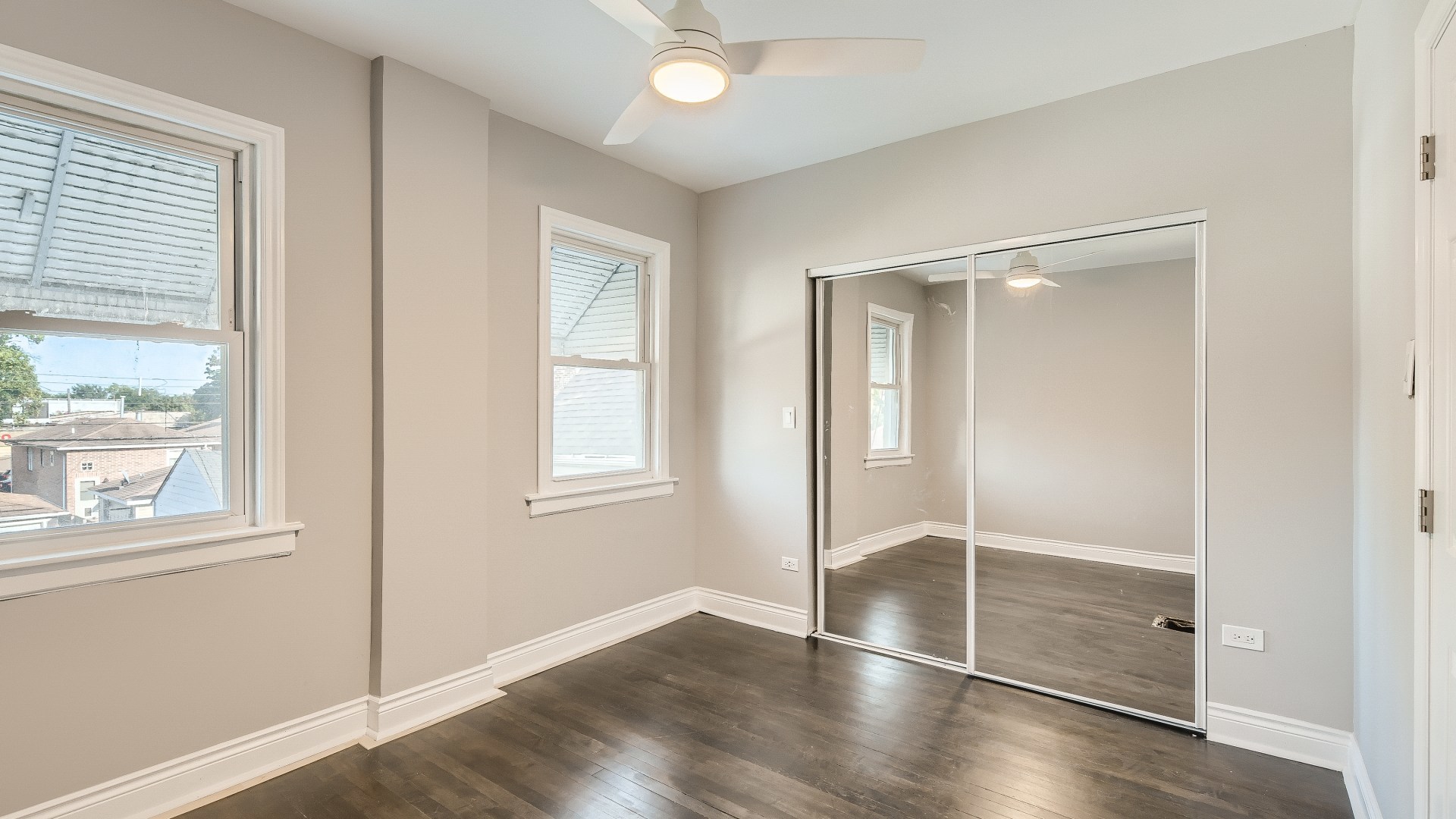 2209 North Kilpatrick Avenue Chicago, IL 60639 - Photo 16 of 22 a view of an empty room with window and wooden floor