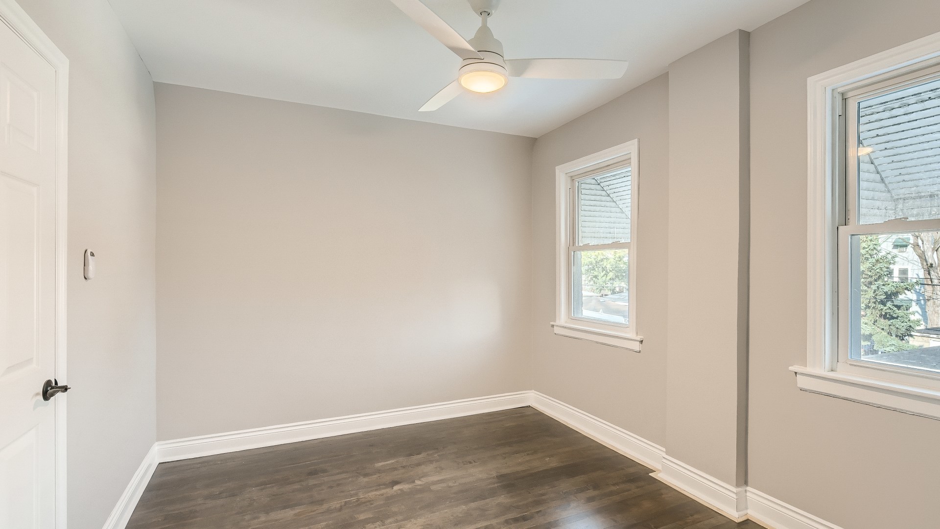 2209 North Kilpatrick Avenue Chicago, IL 60639 - Photo 17 of 22 a view of an empty room with wooden floor and a window