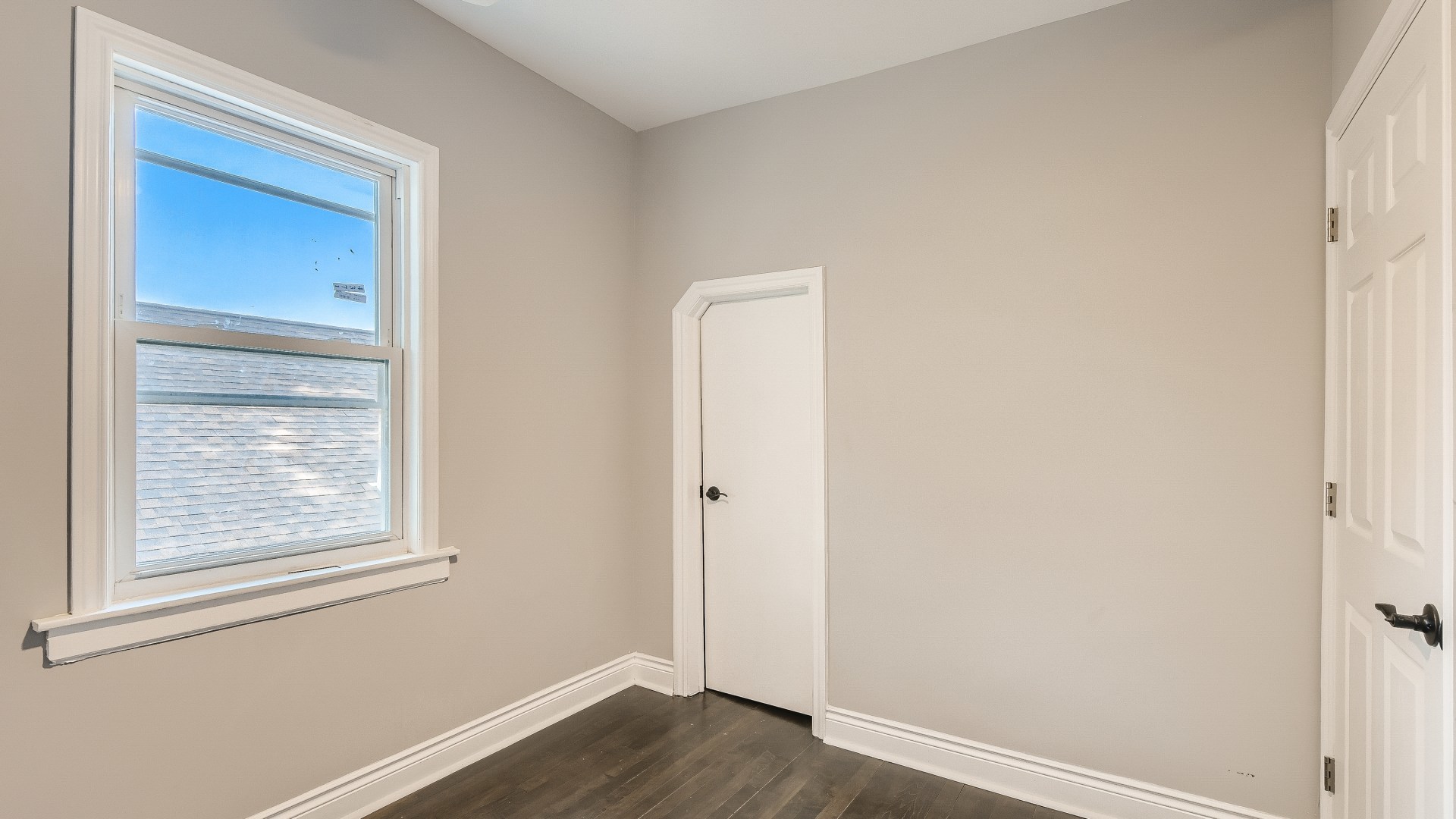 2209 North Kilpatrick Avenue Chicago, IL 60639 - Photo 19 of 22 an empty room with wooden floor and window