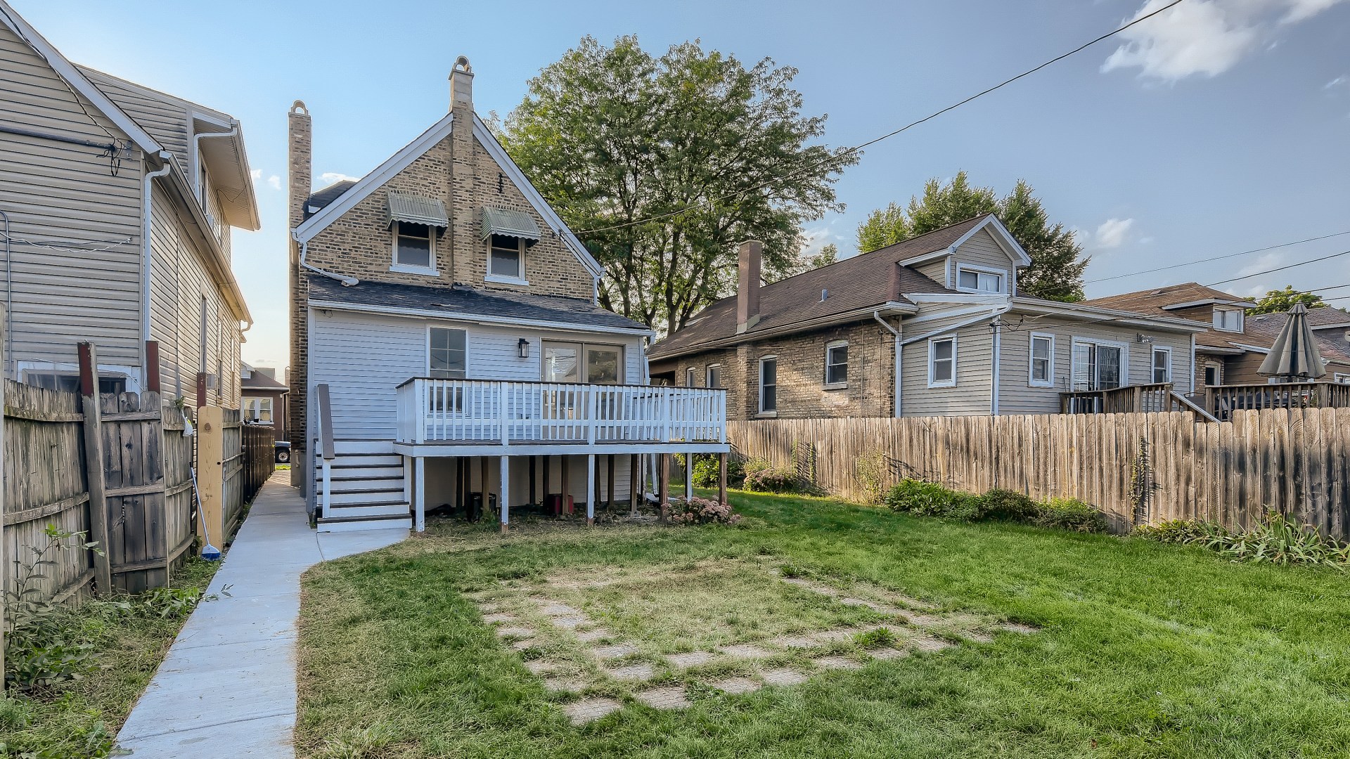 2209 North Kilpatrick Avenue Chicago, IL 60639 - Photo 21 of 22 a front view of a house with a yard