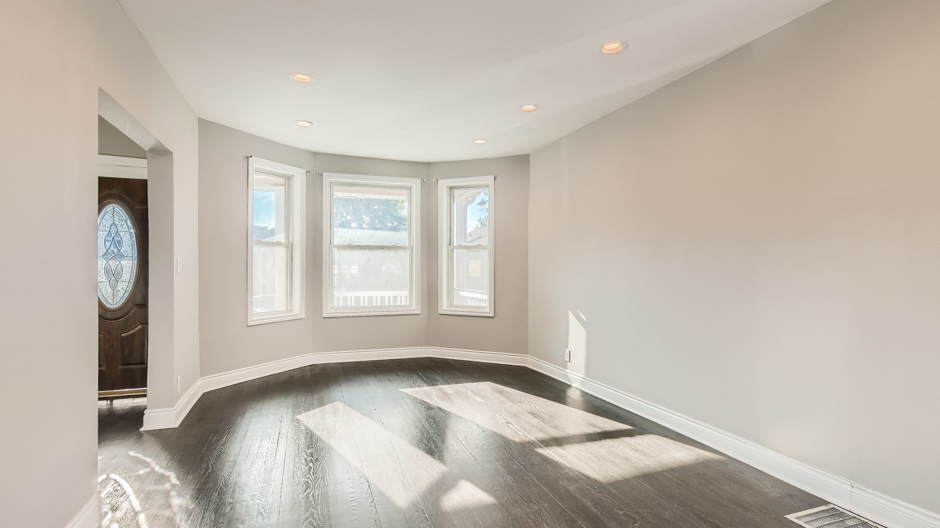 2209 North Kilpatrick Avenue Chicago, IL 60639 - Photo 4 of 22 a view of a livingroom with wooden floor and a window