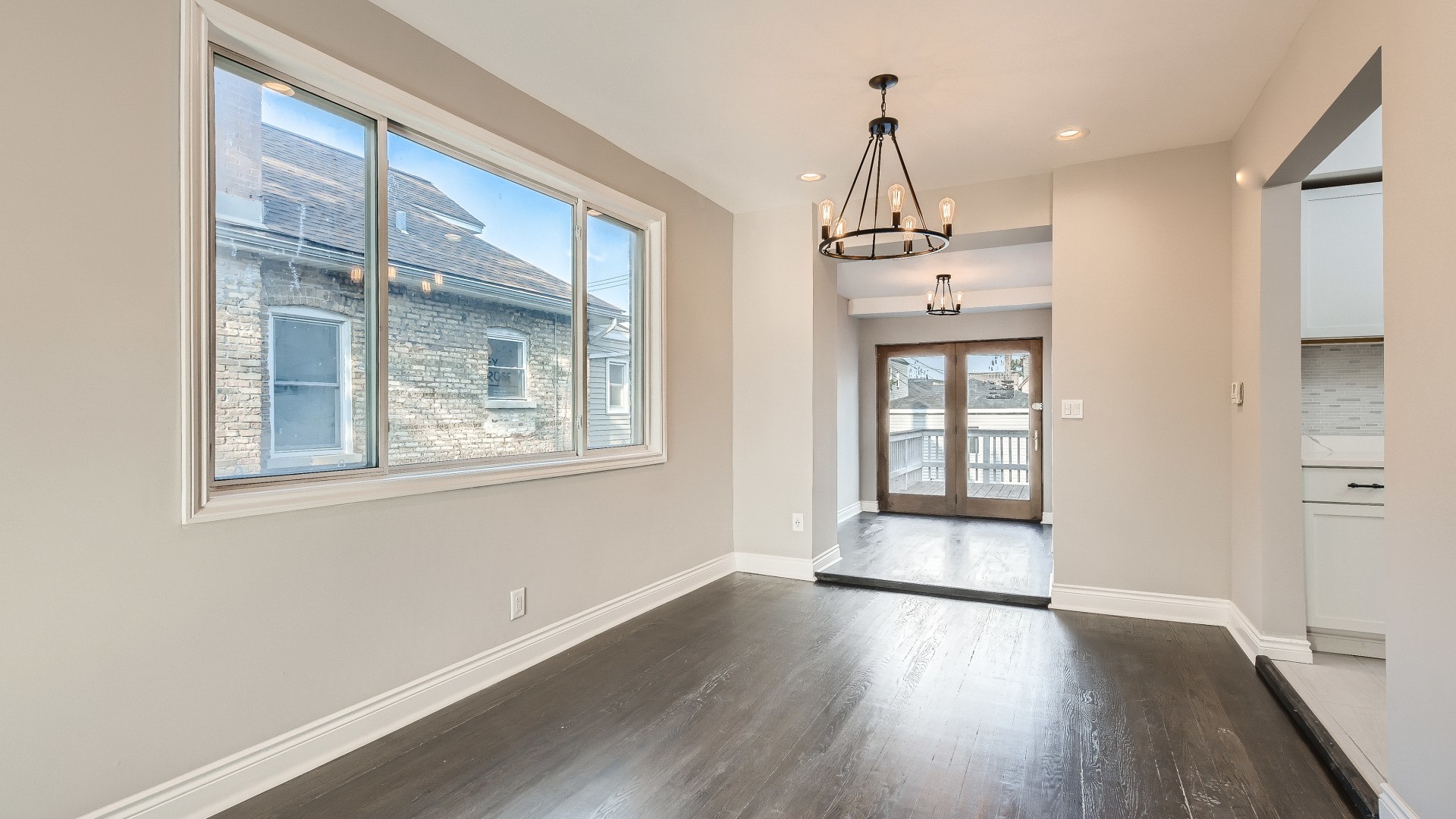 2209 North Kilpatrick Avenue Chicago, IL 60639 - Photo 6 of 22 a view of an empty room with wooden floor and a window