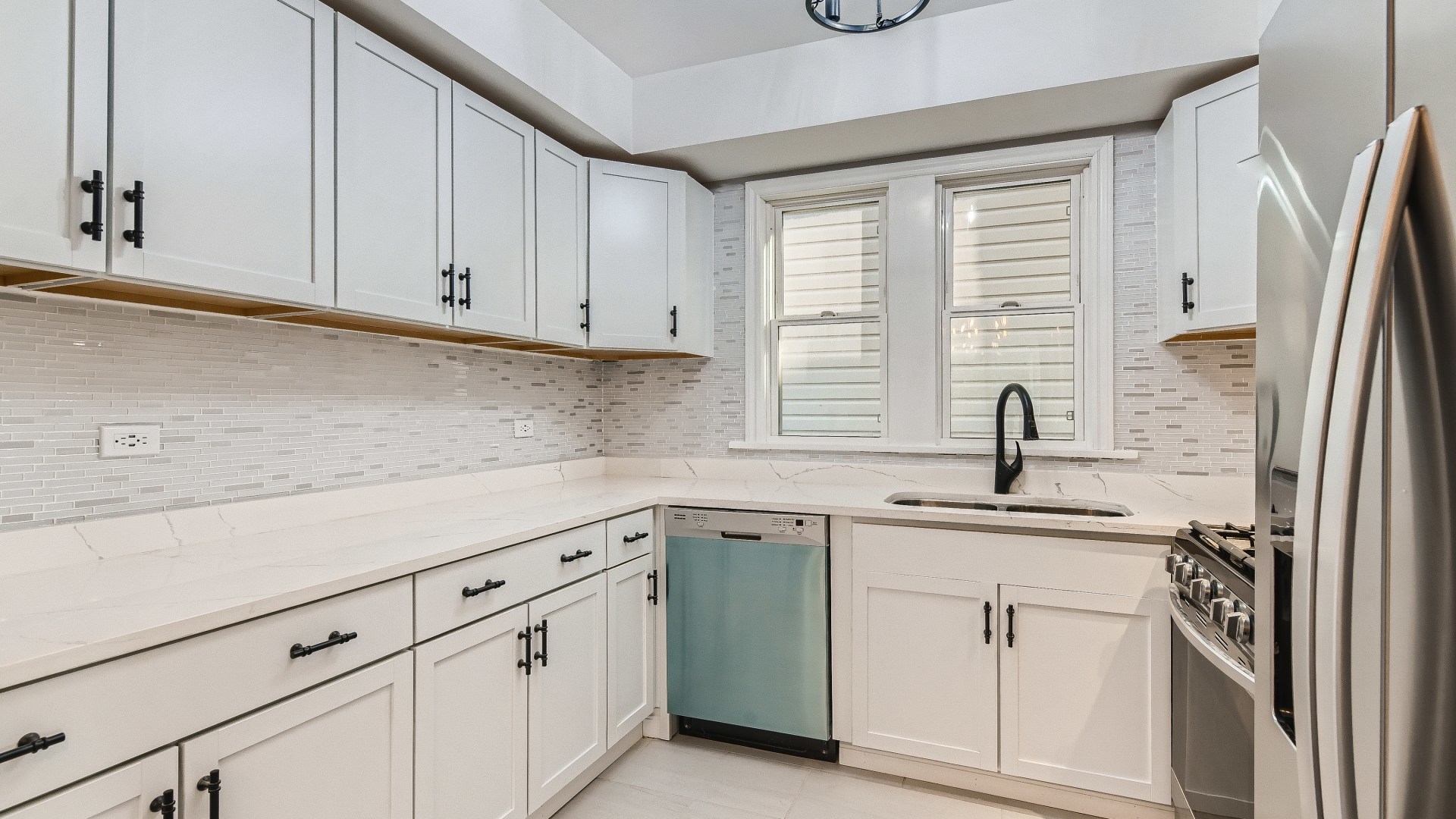 2209 North Kilpatrick Avenue Chicago, IL 60639 - Photo 9 of 22 a kitchen with white cabinets and a sink