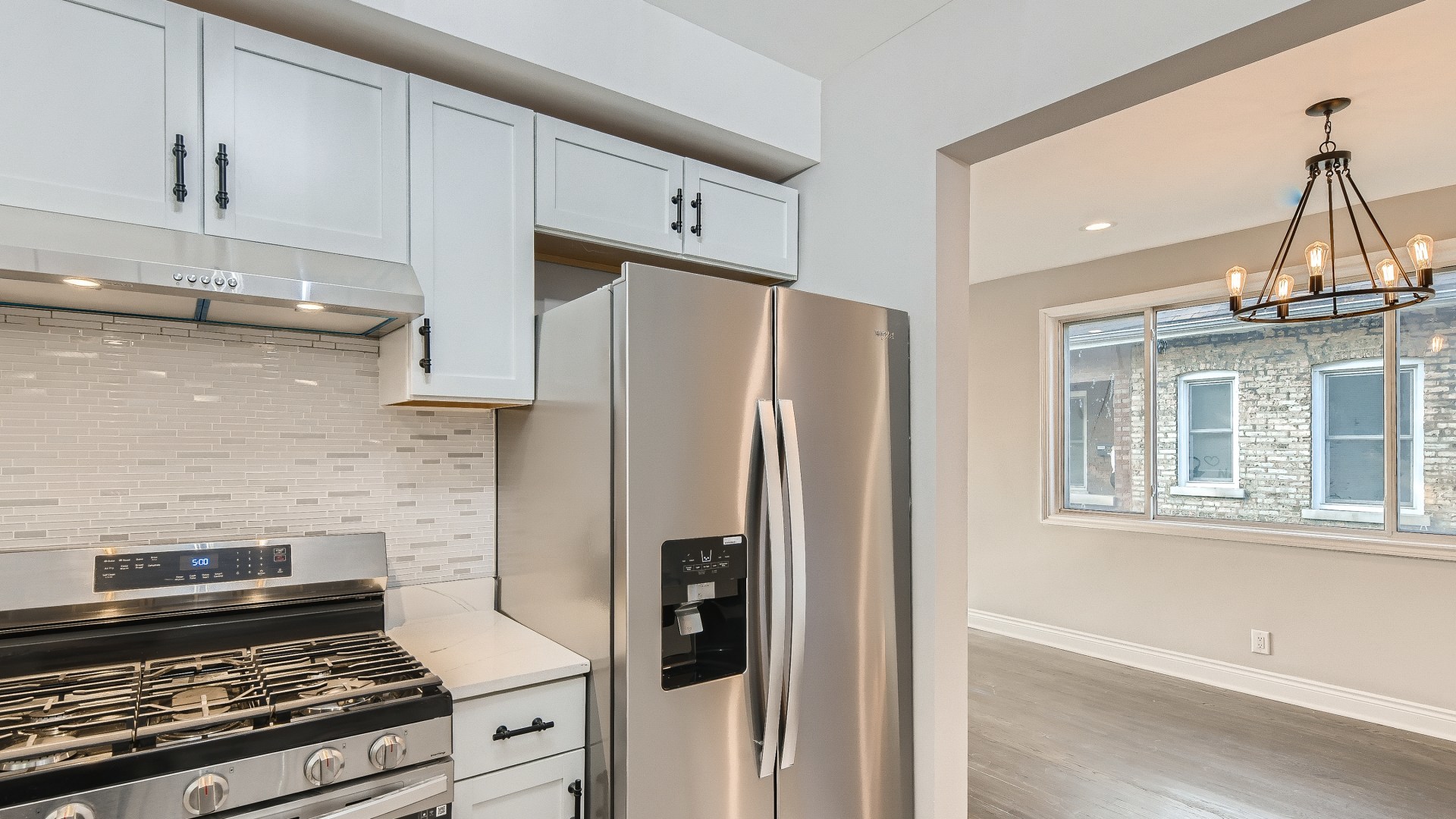 2209 North Kilpatrick Avenue Chicago, IL 60639 - Photo 10 of 22 a kitchen with stainless steel appliances granite countertop a refrigerator a sink and a stove