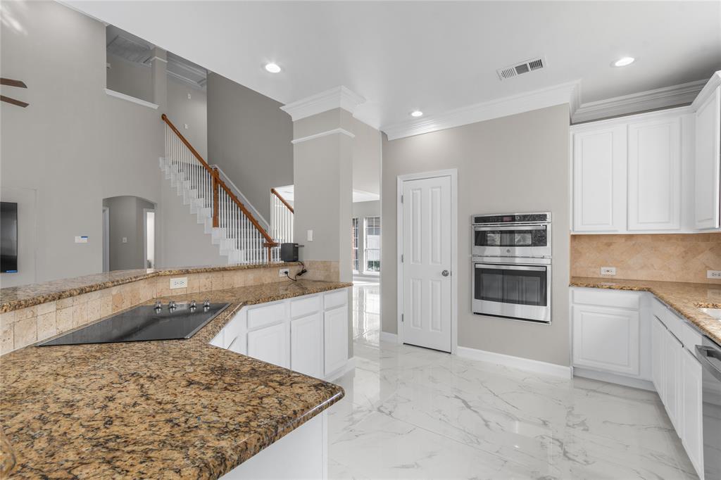 225 Freedom Court Rockwall, TX 75032 - Photo 11 of 28 a kitchen with stainless steel appliances granite countertop a refrigerator and a sink