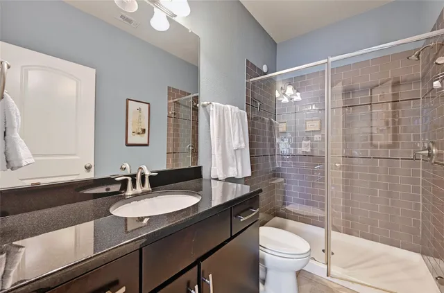 a bathroom with a sink toilet and shower