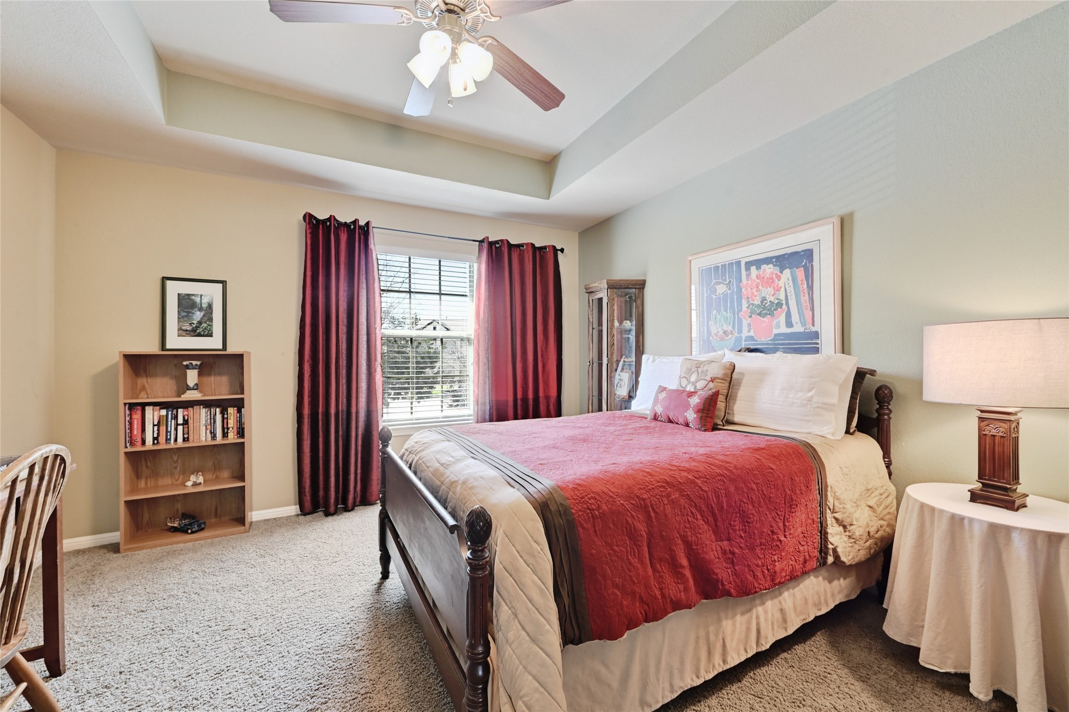 11317 Lost Maples Trail Austin, TX 78748 - Photo 21 of 26 a spacious bedroom with a bed a dresser and book shelf