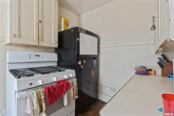 a kitchen with stainless steel appliances granite countertop a refrigerator and a stove