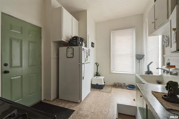 a kitchen with a refrigerator and a sink