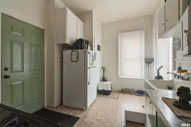 a kitchen with a refrigerator and a sink