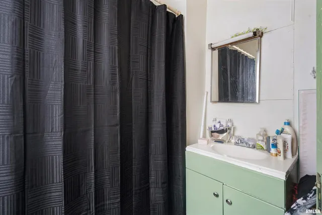 a bathroom with a sink vanity and mirror