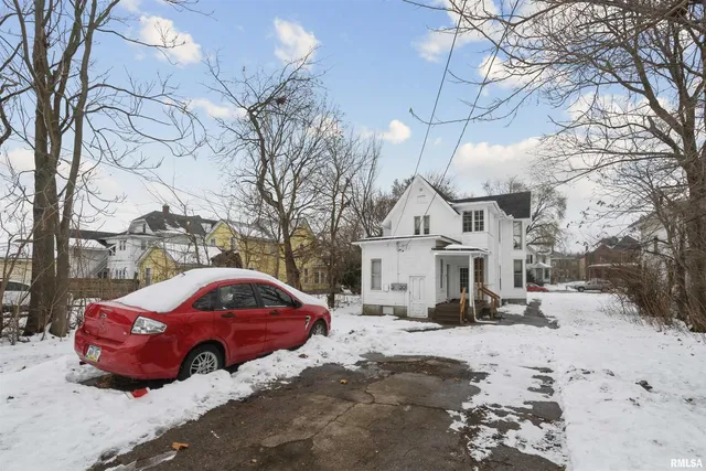 a view of a house with a snow in the yard
