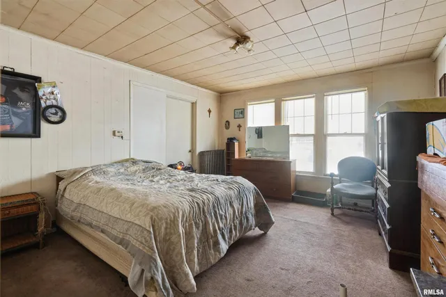 a bedroom with a bed and a chair