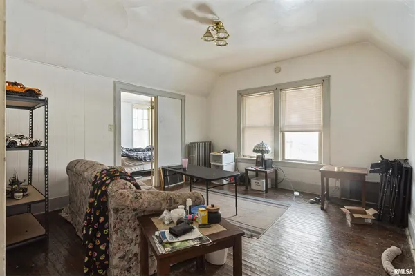 a living room with furniture a flat screen tv and a window