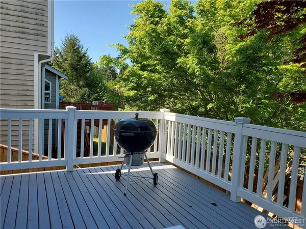 a view of balcony with wooden floor and outdoor seating