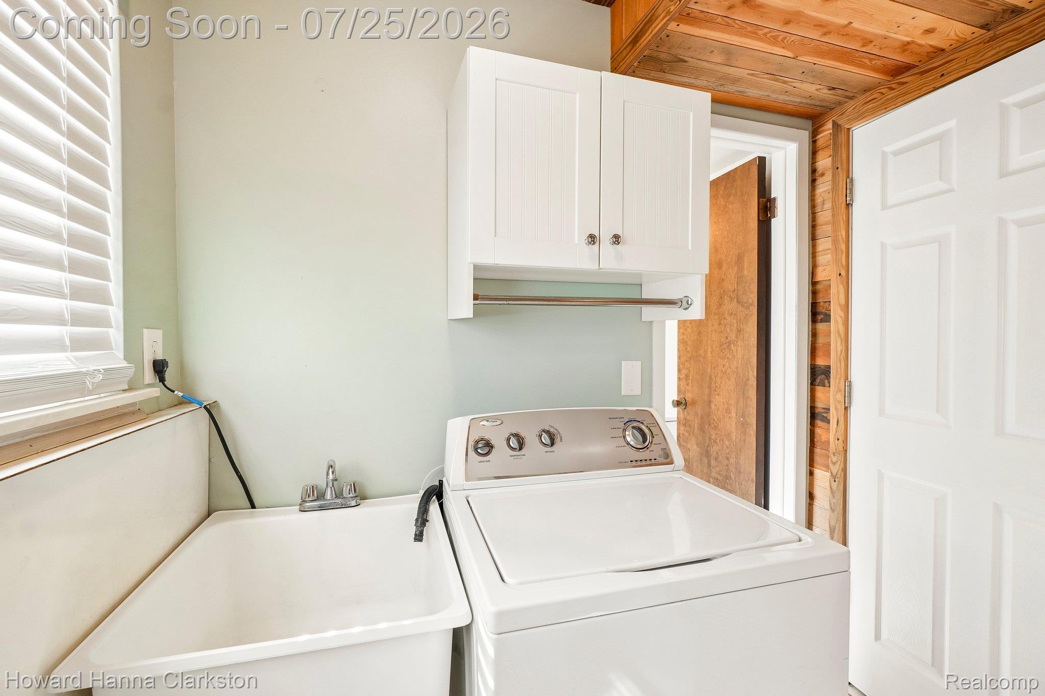 950 Beardon Road Lake Orion, MI 48362 - Photo 26 of 40 Lower level laundry with storage. Door ahead to the 1/2 bath. Door to the right leads to the family room.