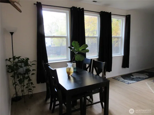 a view of a dining room with furniture and window
