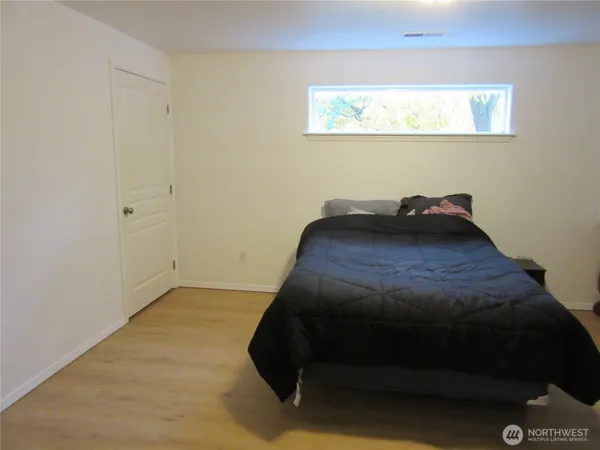 a bed sitting in a bedroom next to a window