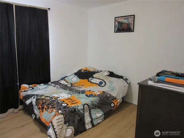 a bedroom with a bed and a cabinet