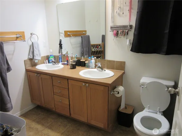 a bathroom with a toilet sink and mirror