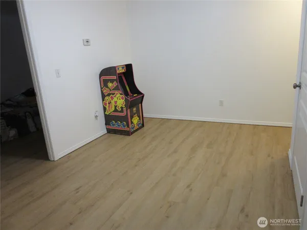 a view of staircase with mirror and wooden floor