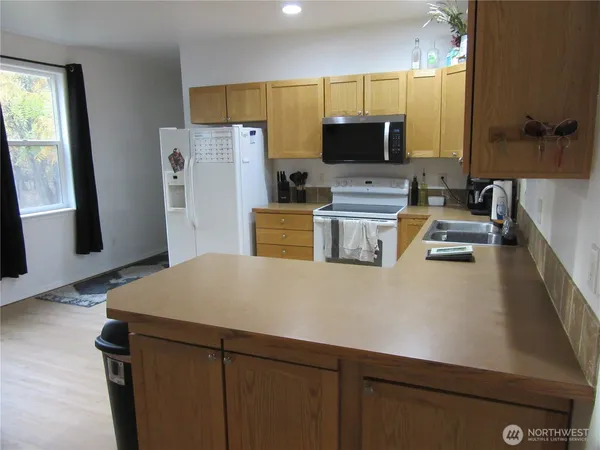 a kitchen with a sink a stove and a refrigerator