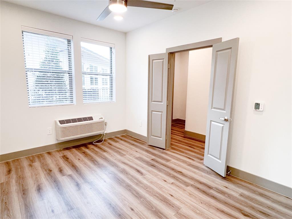 4020 McEwen Road, Unit 3103 Farmers Branch, TX 75244 - Photo 13 of 27 a view of a room with wooden floor and window
