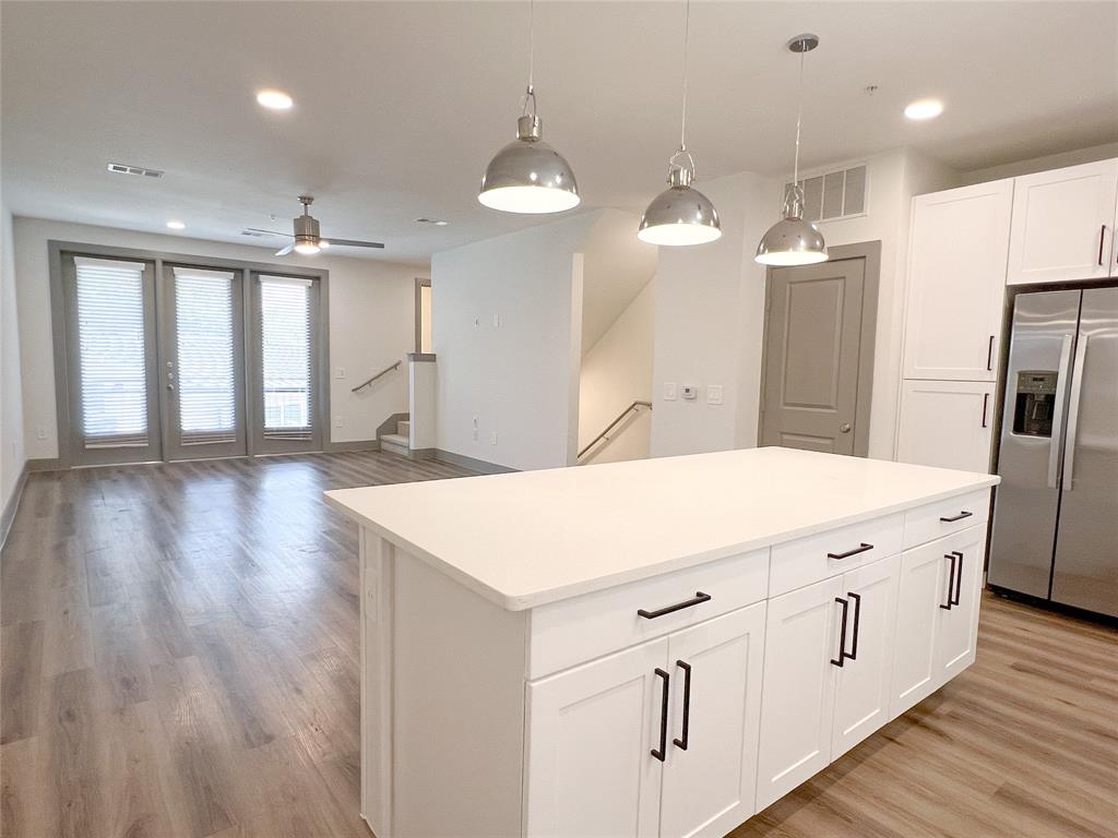 4020 McEwen Road, Unit 3103 Farmers Branch, TX 75244 - Photo 4 of 27 a kitchen with a refrigerator a sink and wooden floor
