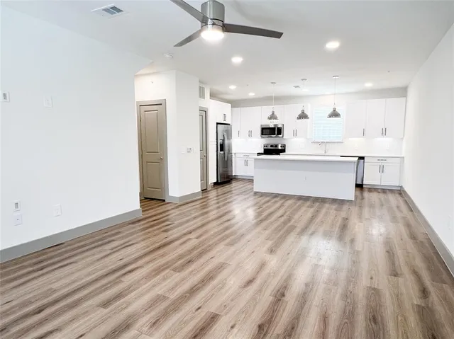 a view of a yard with wooden fence