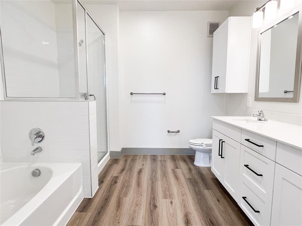 4020 McEwen Road, Unit 3103 Farmers Branch, TX 75244 - Photo 6 of 27 a spacious bathroom with a double vanity sink a mirror and a bathtub