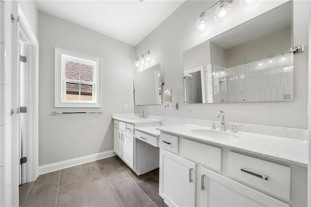 a bathroom with a sink a vanity a mirror and a window